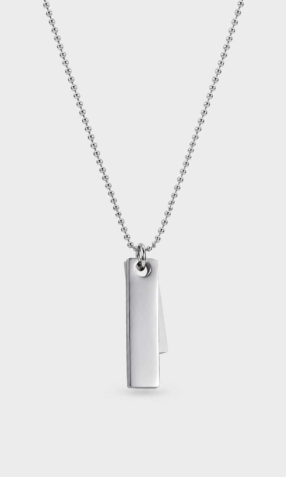 A silver-toned ball chain necklace with a minimalist vertical rectangular pendant, shown against a light gray background.