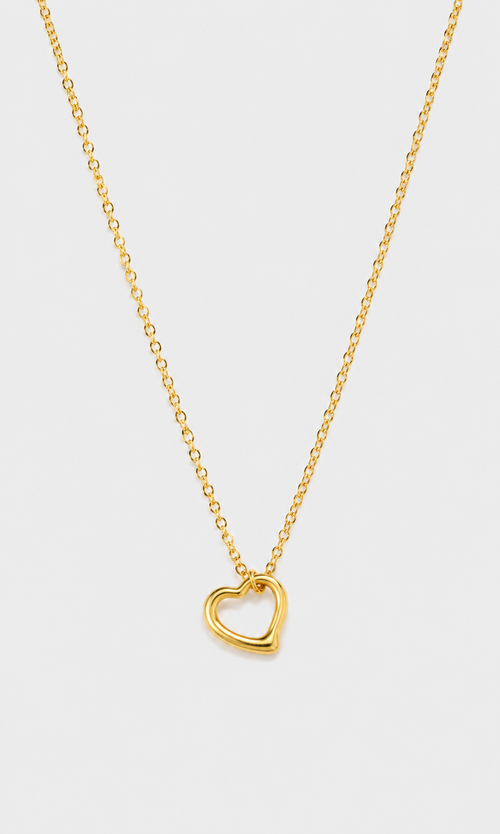 A delicate gold chain necklace featuring a small, polished open heart pendant, displayed against a clean, light gray background.