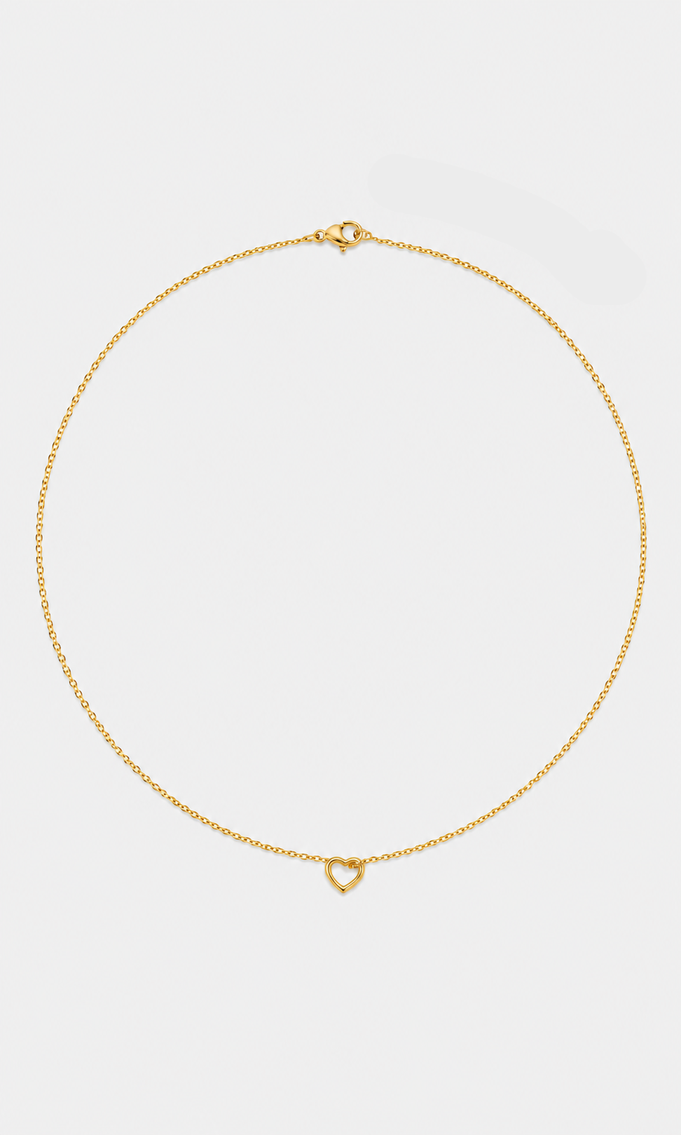 A delicate gold chain necklace with a small open heart pendant, displayed on a clean light gray background.
