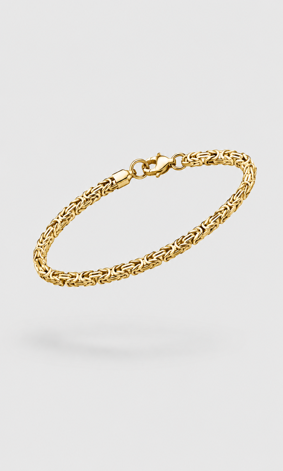 A gold-toned metal chain bracelet with a lobster clasp, displayed on a light gray background.