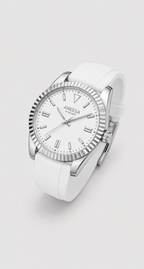 An Aneesa Atelier brand wristwatch featuring a white dial, silver-tone fluted bezel, and a white silicone strap, shown on a light gray background.