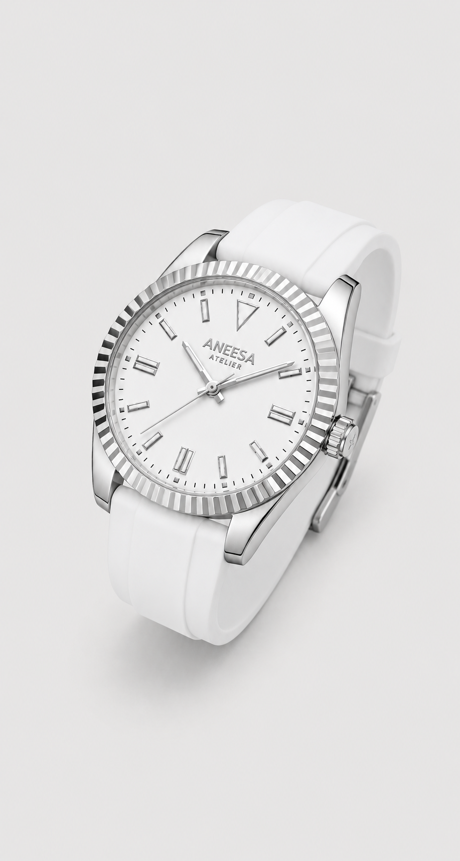 An Aneesa Atelier brand wristwatch featuring a white dial, silver-tone fluted bezel, and a white silicone strap, shown on a light gray background.