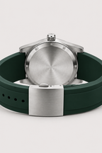 Aneesa wrist watch with a green dial and green rubber strap, featuring a silver fluted bezel and date window, shown against a light gray background.
