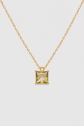 A gold chain necklace with a small square yellow gemstone pendant, displayed against a light gray background.