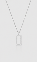 A silver-toned necklace with a minimalist rectangular frame pendant, suspended on a delicate chain against a light gray background.