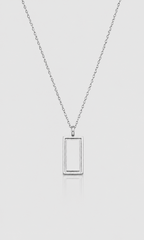 A silver-toned necklace with a minimalist rectangular frame pendant, suspended on a delicate chain against a light gray background.
