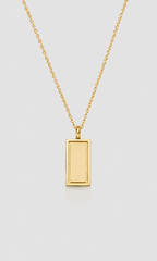 A gold rectangular pendant necklace with a smooth, polished finish on a delicate gold chain, presented on a light gray background.