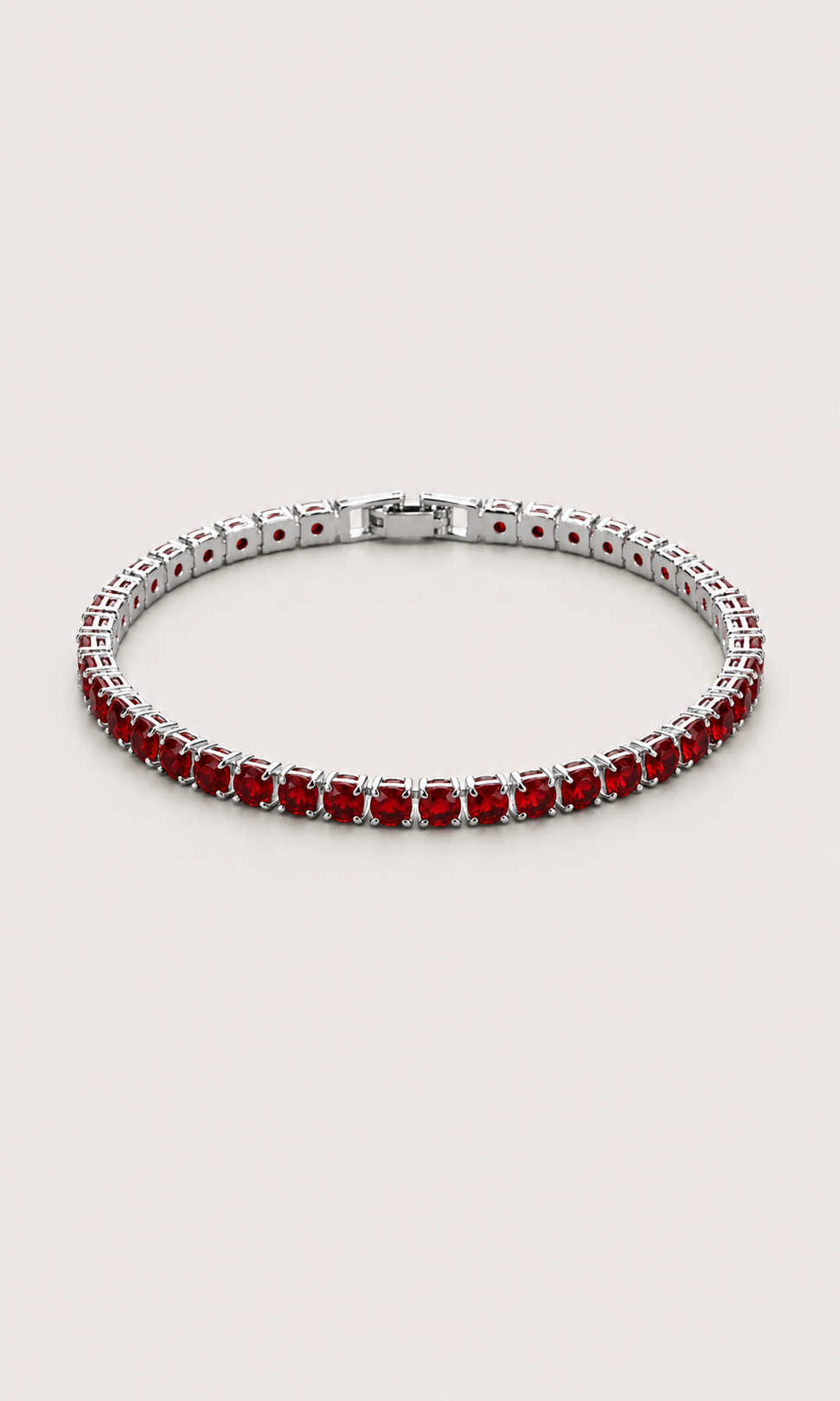 A silver tennis bracelet featuring round-cut red gemstones, displayed on a light beige background.