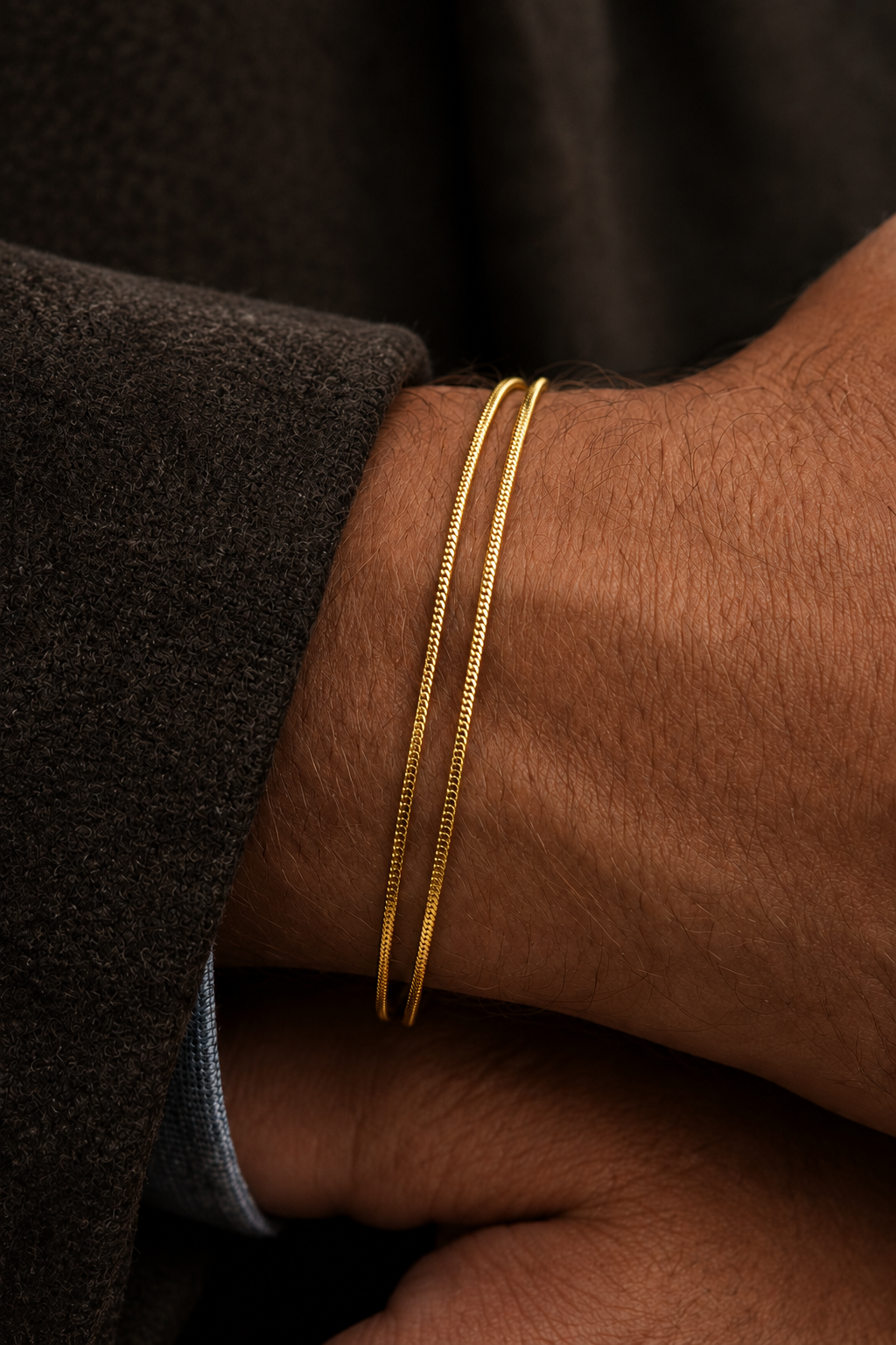 A gold snake chain necklace with a lobster clasp and a small rectangular tag engraved with the brand name 'Aneesa', displayed on a light gray background.