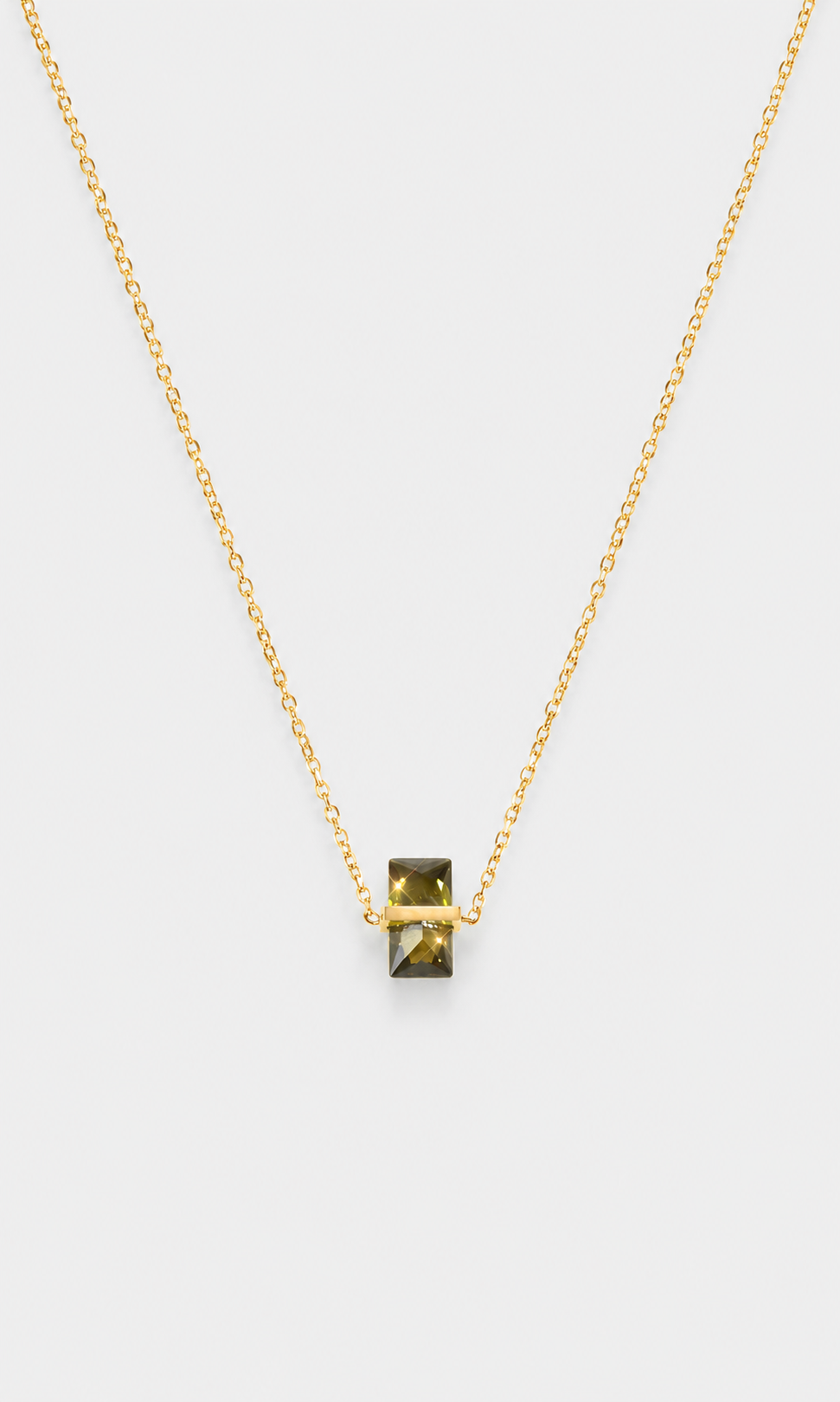 Shop the ANEESA Sage — a gold-plated pendant necklace with a baguette zircon stone. Delicate cable chain design